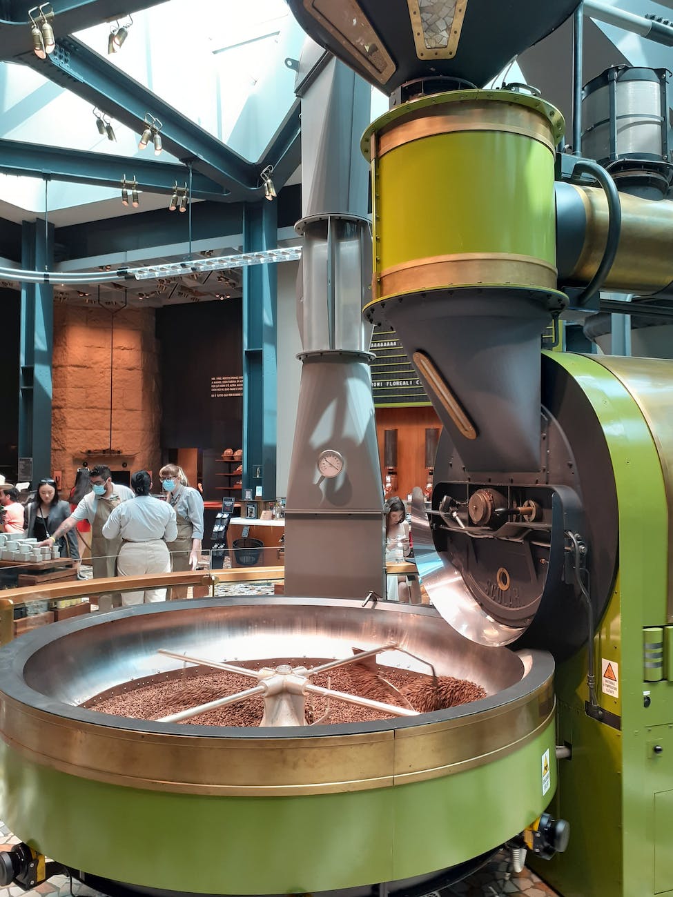 metal grinder and visitors in a chocolate factory